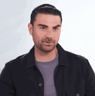 Man With Beard In Black Jacket And Purple Shirt GIF