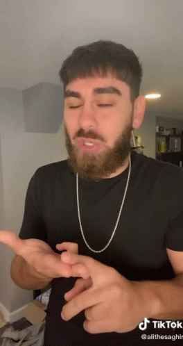 Man with Beard in Black Shirt and Chain