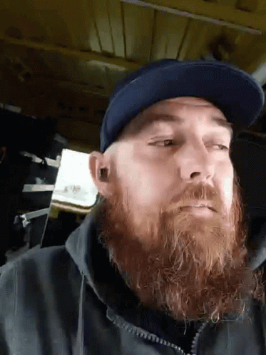 Man with Beard in Blue Hat and Black Jacket