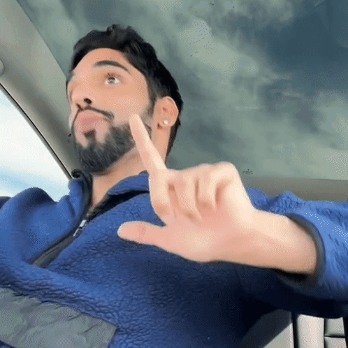 Man With Beard in Blue Jacket Thumbs Down