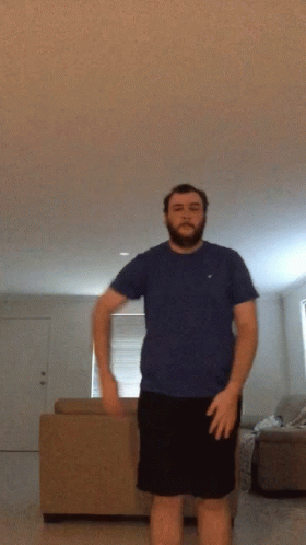 Man with Beard in Blue Shirt and Black Shorts