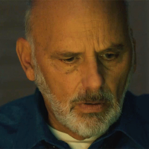 Man with Beard in Blue Shirt Looking Down