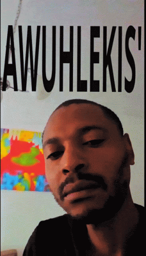 Man With Beard In Front Of Awuhlekis Poster GIF