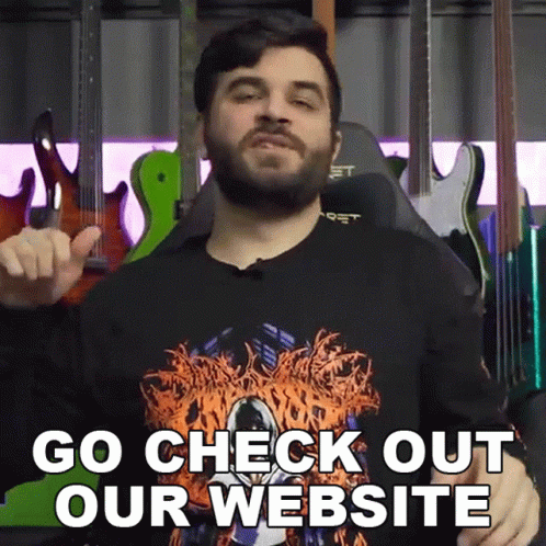 Man With Beard in Front of Guitars Says Go Check Out Our Website
