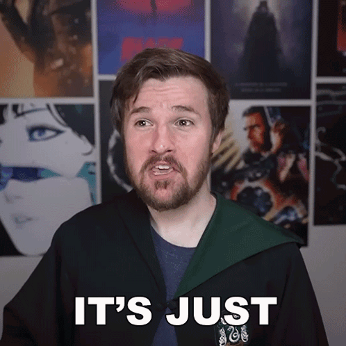 Man With Beard In Front Of Movie Posters GIF