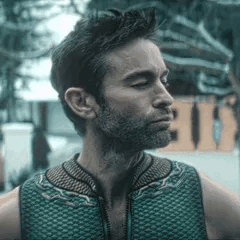 Man with Beard in Green Vest Looking Sideways