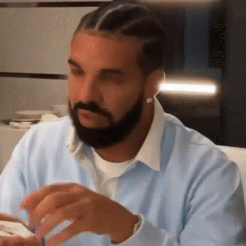 Man With Beard In Light Blue Shirt And Earrings GIF