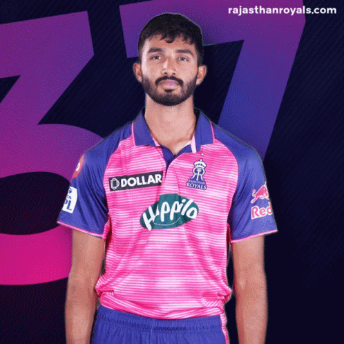 Man With Beard in Pink and Blue Jersey Saying Dollar