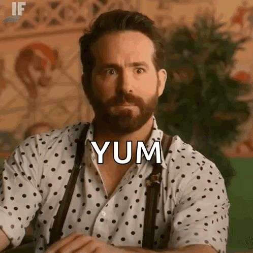 Man with Beard in Polka Dot Shirt Saying Yum