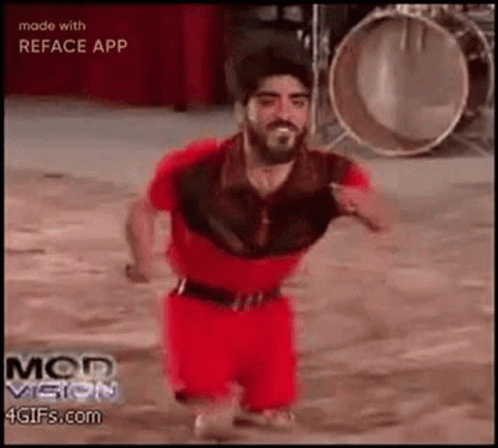 Man With Beard In Red Shirt And Shorts Dancing At Drums GIF