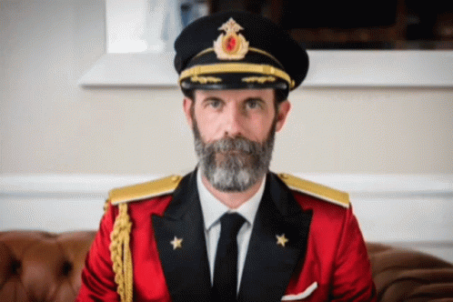Man with Beard in Red Suit and Black Hat