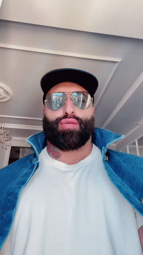 Man with Beard in Sunglasses and Baseball Cap