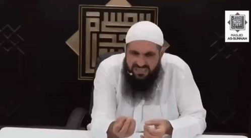 Man with Beard in White Hat Sitting at Table