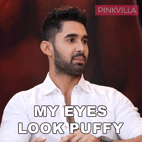 Man With Beard in White Shirt Saying My Eyes Look Puffy