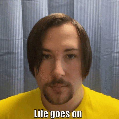 Man With Beard in Yellow Shirt Saying Life Goes On