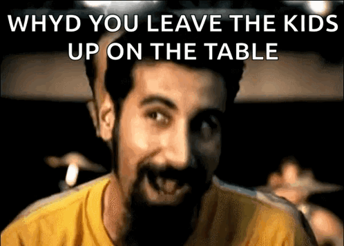Man with Beard in Yellow Shirt Saying Why