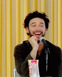 Man With Beard Laughing At Microphone GIF