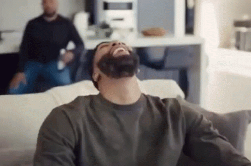 Man with Beard Laughing on Couch