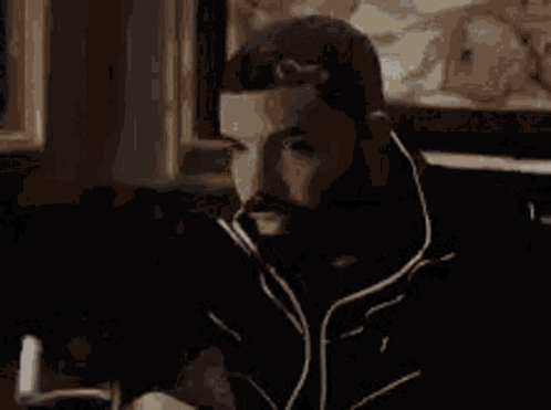 Man with Beard Looking at Cell Phone