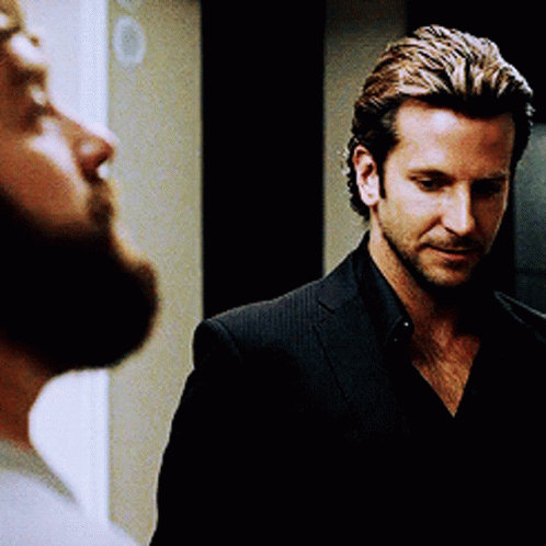 Man with Beard Looking at Man in Black Suit