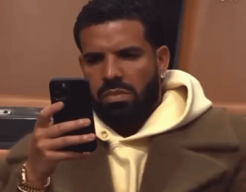 Man with Beard Looking at Phone
