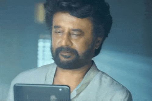 Man With Beard Looking at Tablet Computer