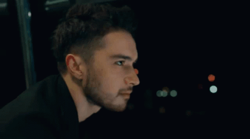 Man With Beard Looking In Dark GIF