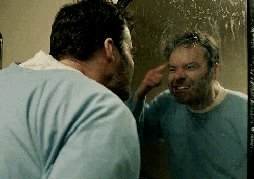 Man With Beard Looking in Mirror