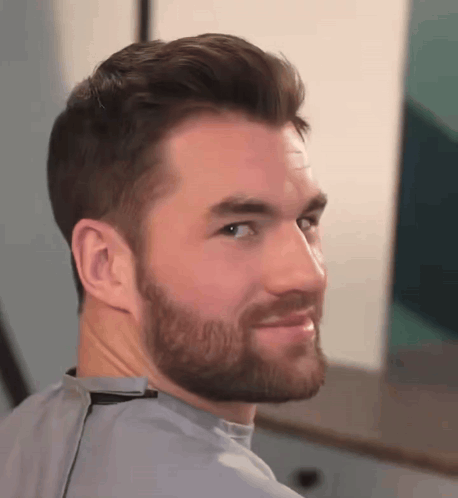 Man With Beard Looking Over Shoulder GIF