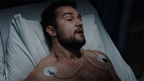 Man With Beard Lying in Hospital Bed Eyes Closed