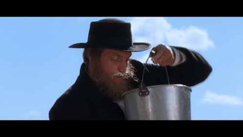 Man with Beard Pouring Into Pot