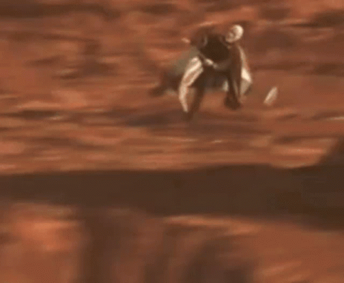 Man with Beard Riding Scooter in Sand
