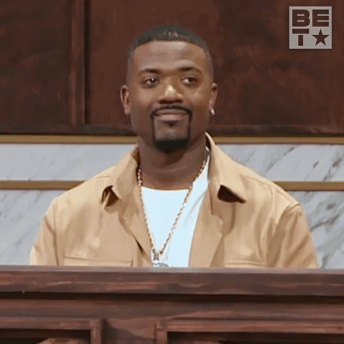 Man With Beard Sitting at Podium Saying Be