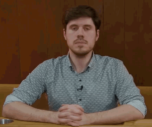 Man with Beard Sitting at Table