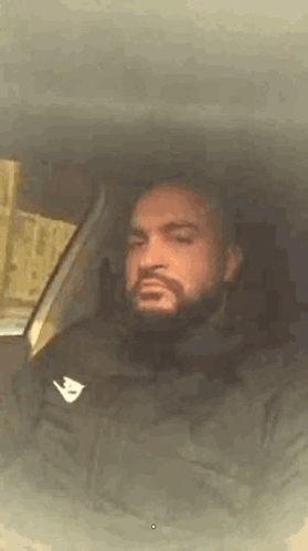 Man with Beard Sitting in Car