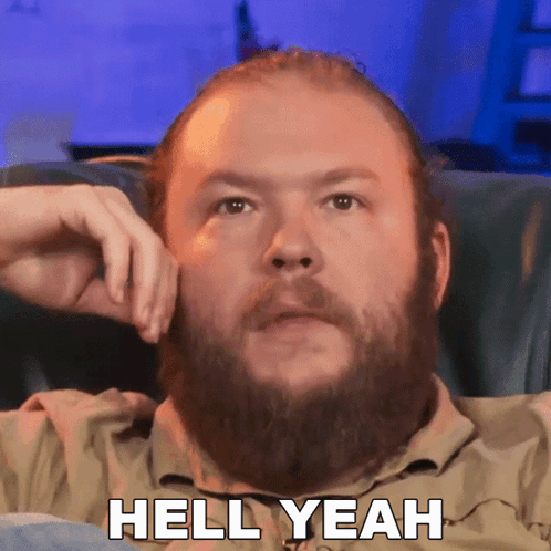 Man With Beard Sitting in Chair Hell Yeah