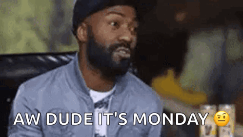 Man With Beard Sitting in Chair Saying Aw Dude Its Monday