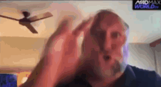 Man With Beard Sitting In Front Of Ceiling Fan GIF