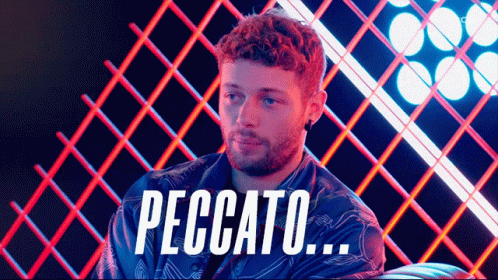 Man With Beard Sitting In Front Of Peccato Fence GIF