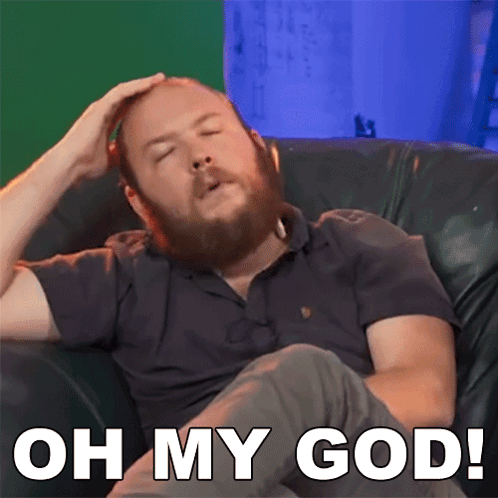 Man with Beard Sitting on Couch Saying Oh My God