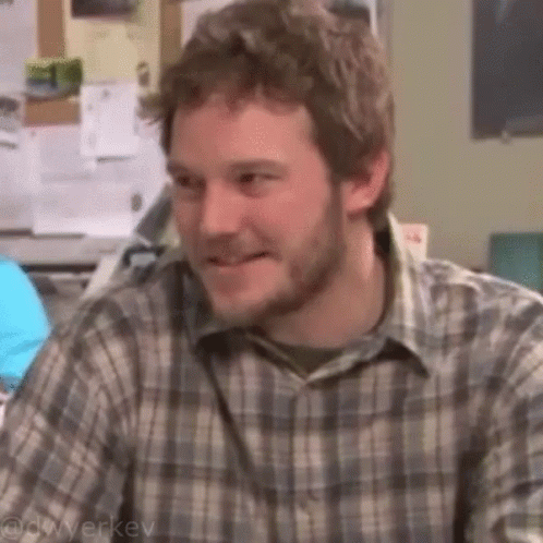 Man with Beard Smiling at Desk