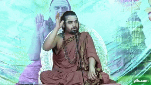 Man With Beard Smiling at Microphone Shri Radha Kripa
