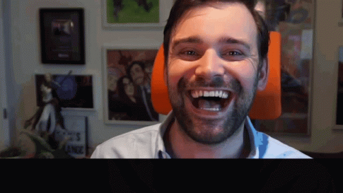 Man with Beard Smiling at Sign Ance