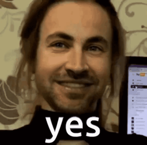 Man with Beard Smiling at Yes Screen