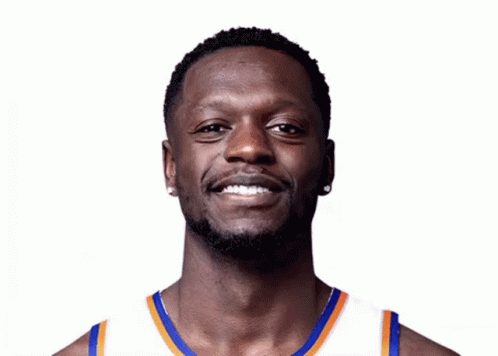 Man with Beard Smiling in Blue and Orange Jersey