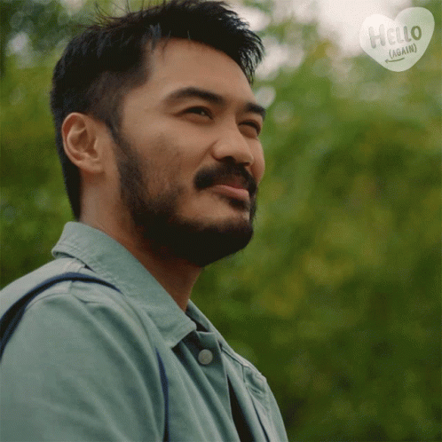 Man With Beard Smiling In Front Of Hello Again Sign GIF
