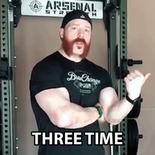Man With Beard Standing Before Arsenal Strength Sign GIF