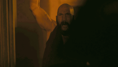 Man With Beard Standing In Dark GIF