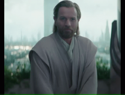 Man With Beard Standing in Front of Large Window