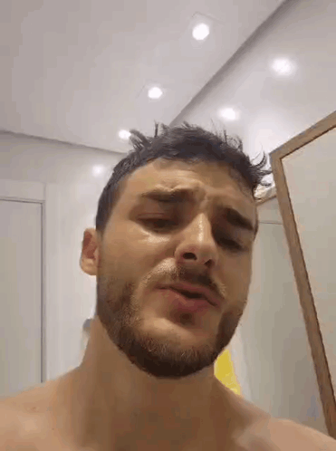 Man With Beard Standing In Front Of Mirror GIF